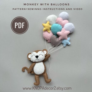 May include: A PDF pattern for a felt monkey holding a bunch of colorful balloons. The balloons are pink, blue, yellow, white, and gray. The monkey is brown with a white belly and a happy face. The pattern includes sewing instructions and a video tutorial.  www.KNOPAdecor2.etsy.com