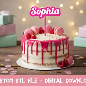 May include: A layered cake with pink frosting drips, topped with pink macarons, raspberries, and a pink "Sophia" cake topper. The cake sits on a white cake board, with gift boxes in the background. The image also contains the text "CUSTOM STL FILE - DIGITAL DOWNLOAD".