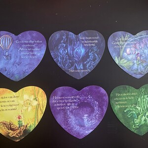 Puede incluir: Seis tarjetas en forma de corazón con citas inspiradoras en holandés. Las tarjetas presentan ilustraciones de hadas, flores y otras imágenes fantásticas. Las citas incluyen: "Gool onnodige ballast owbool", "Alleen met weinig bagage kam je hocig vliegen", "Leder begin wolt wonderbaarlijk bescheid", "Zot welan", "Ook na tijden van diepe duistemis en van lizie kou volgt weer licht en warmte", "Het meest waardevolle, dat je bij je heejaan achtela de spotwin felletle", "Het is alsof er altijd een coor in de lucht mochistem", "le bent nooit alle".