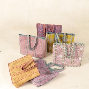 May include: Six colorful tote bags with different patterns and designs. The bags are made of quilted fabric and have a variety of colors, including pink, yellow, blue, and green.