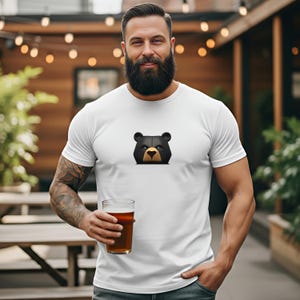 This bearded daddy is showing off his white subtle bear pride shirt featuring a fierce black bear with electric blue eyes.  This muscle bear accentuates the perfect fit of tee creating a woof worthy vibe where ever you go.  The perfect gift for your boyfriend or daddy this holiday season.