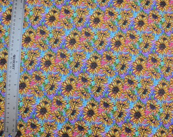 May include: A blue and purple fabric with a repeating pattern of yellow sunflowers. The fabric has the text "Summer Sunflowers" printed in the top left corner.