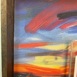 May include: A framed print of a painting with a swirling, abstract sky in shades of blue, red, yellow, and orange. The sky is painted with thick, visible brushstrokes.