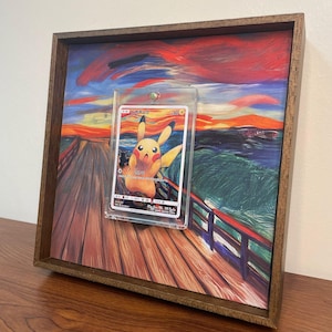 May include: A framed print of "The Scream" by Edvard Munch, with a Pokemon card featuring Pikachu in the center. The card is in a clear plastic protector.