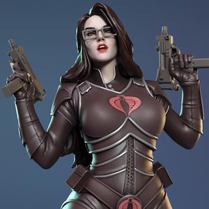 May include: A brown figurine of a woman wearing glasses and a brown bodysuit, holding two guns. The figurine has a Cobra logo on the chest and is posed against a blue background. The figurine is a Torrida Minis product.