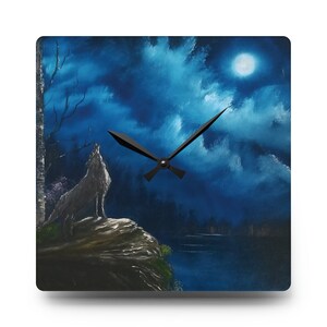 May include: A square clock with a blue and white night sky scene. The clock face is black with black hands. The scene features a wolf howling at the moon, a lake, and trees.