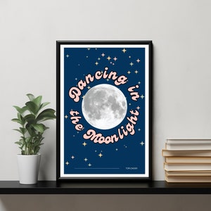 May include: A blue poster with a white moon and pink text that reads "Dancing in the Moonlight". The poster has a dark blue background with gold stars.
