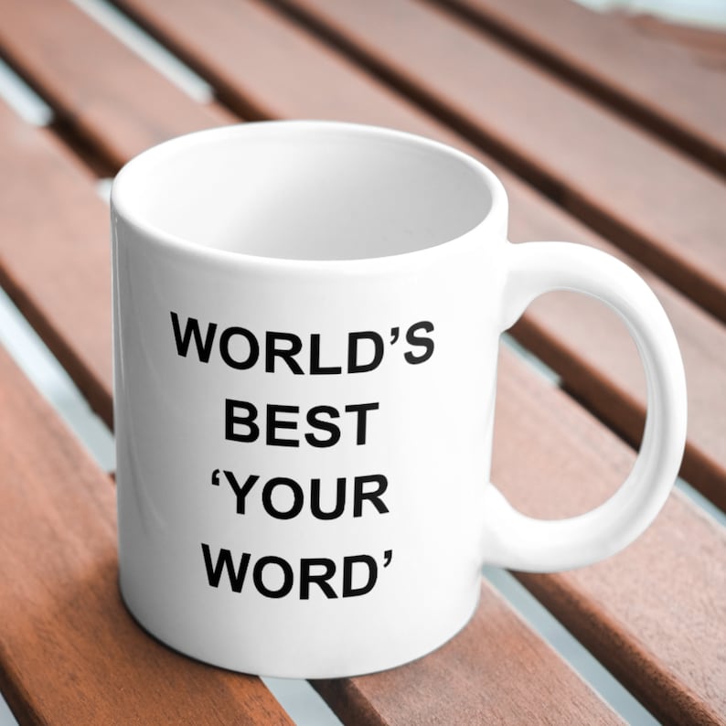 May include: White ceramic mug with black text that reads "WORLD'S BEST 'YOUR WORD'".