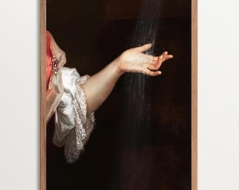 May include: A framed vintage art print featuring a hand reaching out to catch a stream of light or water. The artwork showcases a person's arm and hand, with a dark background and a touch of white lace.