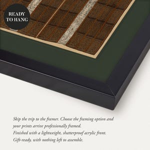 Close up of a brown and cream antique textile art print displayed with a deep green mat and slim black frame. Intricate geometric woven patterns create richly detailed vintage wall art, shown with the professionally framed ready to hang option.