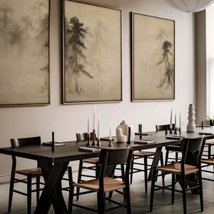 Set of three framed Japanese sumi-e ink paintings featuring misty pine trees, displayed in a modern dining room with dark wood furniture and minimalist Japandi decor. The soft, earthy tones create a tranquil and elegant atmosphere.