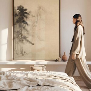 Framed Japanese sumi-e ink painting on a large canvas, depicting misty pine trees in a traditional Zen-inspired style. Displayed in a modern bedroom with neutral decor, emphasizing a calming, meditative ambiance.