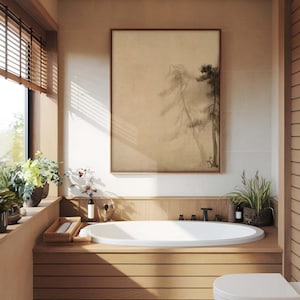 Wabi-sabi framed canvas wall art with a serene pine tree design, displayed above a wooden bathtub in a bright, natural light-filled bathroom with soft beige tones.
