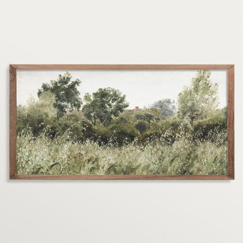 A framed panoramic greenery print with soft natural tones and painterly tree forms, blending into a light wall. The horizontal composition adds understated elegance to Japandi interiors, offering calming Wabi Sabi texture and nature-inspired design.