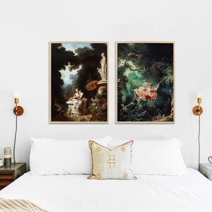 May include: Two framed paintings depicting scenes from nature. The painting on the left shows a woman sitting on a stone bench in a lush green forest. The painting on the right shows a woman swinging on a rope swing in a forest.
