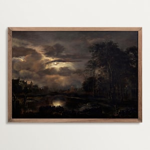 Framed dark landscape art print showing a dramatic night sky with glowing moonlight over clouds, trees, and a river, in a classic wooden frame.