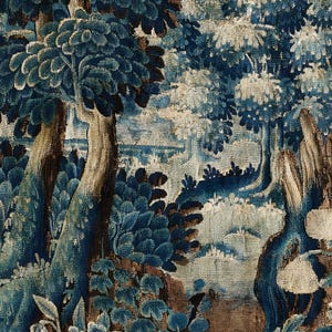 Close-up of the verdure tapestry print showing intricate woven texture, deep blue leaves and aged brown accents. The detailed botanical pattern emphasizes the historic textile look and the richness of the fine art print.