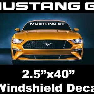May include: A yellow Mustang GT car with a black grill and the text "MUSTANG GT" in white. The image also includes a 2.5"x40" windshield decal.