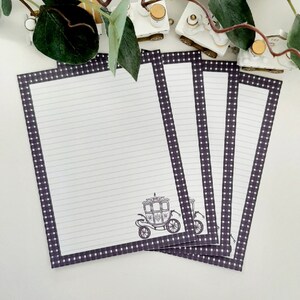 May include: Four sheets of lined stationery with a dark purple and white polka dot border. Each sheet features a black carriage illustration in the lower center. The paper is white with horizontal gray lines.