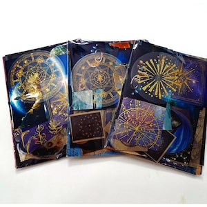 May include: Three rectangular packs of decorative stickers featuring celestial and astronomical themes. Each pack contains various designs with gold foil accents, including circular star charts, constellations, planets, and geometric patterns on dark blue backgrounds.