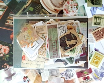 May include: A collection of vintage-style ephemera, including stamps, labels, and paper scraps, arranged in a clear plastic sleeve. The items feature floral, botanical, and text designs in muted colors. Some pieces have text that reads "PARTY" and "OF CHERRIE".