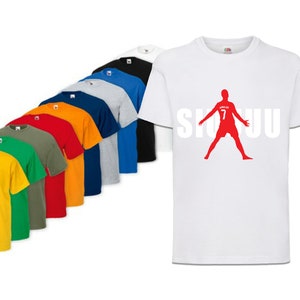 May include: A white t-shirt with a red silhouette of a soccer player with the number 7 on the back and the word "SIUU" printed in white letters.