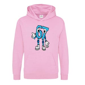 May include: A light pink hooded sweatshirt featuring a cartoon character made of the numbers 6 and 7 in light blue. The character has arms, legs, and feet, and is smiling. The sweatshirt has a kangaroo pocket and a drawstring hood.