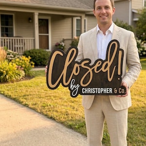 May include: A dark brown wooden sign with light tan lettering that reads Closed! by CHRISTOPHER & Co. The sign features a large script font for the word Closed! and a smaller sans-serif font for the remaining text, with a smooth, flat surface.