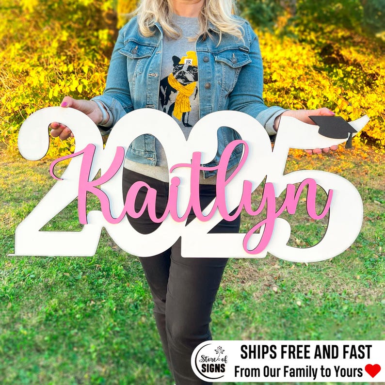Custom wooden graduation sign Senior 2025 with personalized name displayed outdoors on lawn