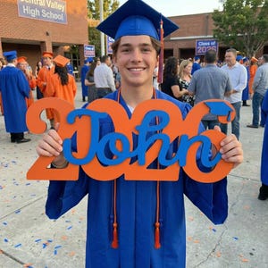 senior graduation photo setup using wooden name sign