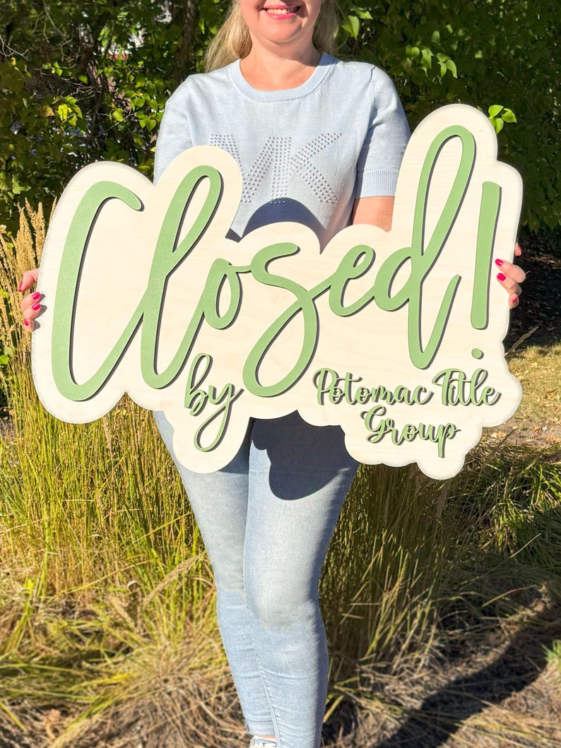 real estate branding sign sold by agent wood