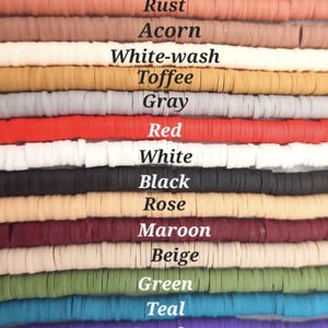 May include: Fifteen horizontal strands of flat, circular clay beads arranged in rows. Each row features a distinct color labeled with text: Burgandy, Rust, Acorn, White-wash, Toffee, Gray, Red, White, Black, Rose, Maroon, Beige, Green, Teal, Purple, and Pink blush.