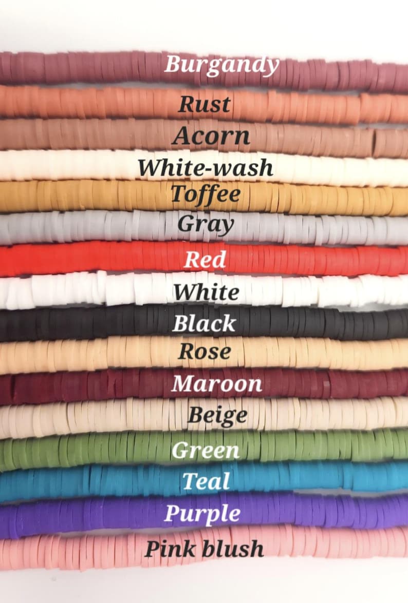 May include: Fifteen horizontal strands of flat, circular clay beads arranged in rows. Each row features a distinct color labeled with text: Burgandy, Rust, Acorn, White-wash, Toffee, Gray, Red, White, Black, Rose, Maroon, Beige, Green, Teal, Purple, and Pink blush.