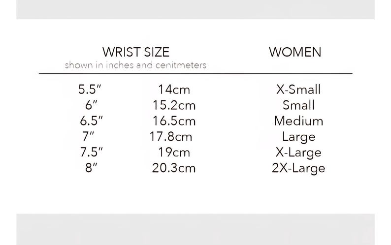 May include: A black and white sizing chart titled WRIST SIZE shown in inches and centimeters, listing measurements from 5.5 inches to 8 inches alongside corresponding metric values and size labels ranging from X-Small to 2X-Large for women.