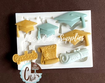 May include: Silicone mold with graduation themed designs. The mold features a graduation cap, diploma, and the word "Graduate".