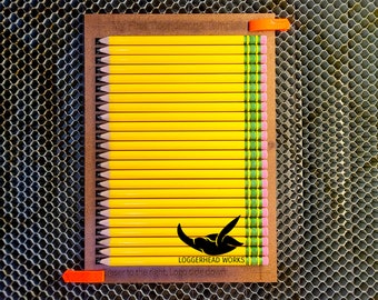 May include: A wooden box filled with 36 yellow pencils with green and white stripes. The box has a logo for Loggerhead Works and the text "Point to the right, logo side down".