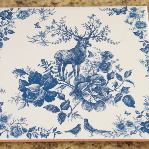 Vintage-style kitchen trivet on ceramic tile. Ceramic tile art with deer and flowers in blue colors. Retro-style tile trivet in blue colors.