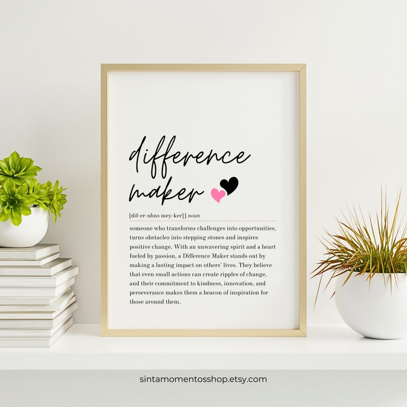 May include: A printable wall art design with a black and white graphic of the word "difference maker" with two pink and black hearts. The definition of a difference maker is written in black text below the graphic. The text reads: "someone who transforms challenges into opportunities, turns obstacles into stepping stones and inspires positive change. With an unwavering spirit and a heart fueled by passion, a Difference Maker stands out by making a lasting impact on others' lives. They believe that even small actions can create ripples of change, and their commitment to kindness, innovation, and perseverance makes them a beacon of inspiration for those around them."