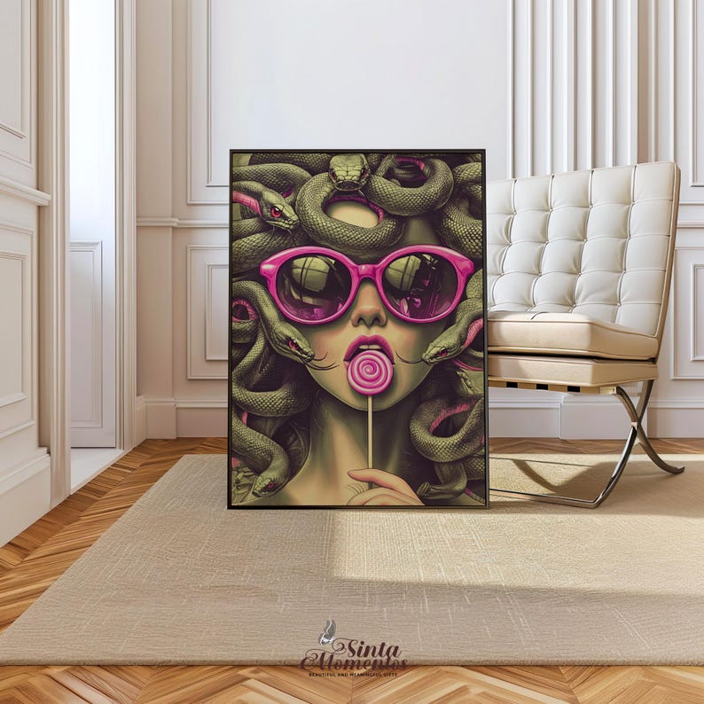 May include: A framed art print featuring a stylized illustration of Medusa wearing pink sunglasses and holding a lollipop. Her hair is composed of green snakes. The artwork has a modern, pop art style with vibrant colors and bold lines.