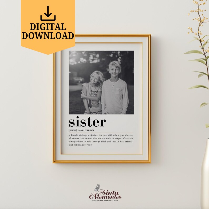 May include: A black and white photograph of two siblings, a boy and a girl, standing close together. The photo is framed in a gold frame and has a definition of the word "sister" with the girl's name, Hannah, below it.