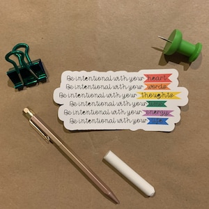 May include: A sticker with a rainbow design and the text "Be intentional with your heart, words, thoughts, time, energy, life".