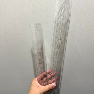 May include: Two clear plastic stencils with a geometric pattern. The stencils are labeled "The Miss Patina".