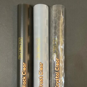 May include: Three clear plastic tubes with different finishes: black, frosted, and crystal clear. Each tube has a gold label with the text "The Mess Pole" and the finish name: "Black Clear", "Frost Clear", and "Crystal Clear".