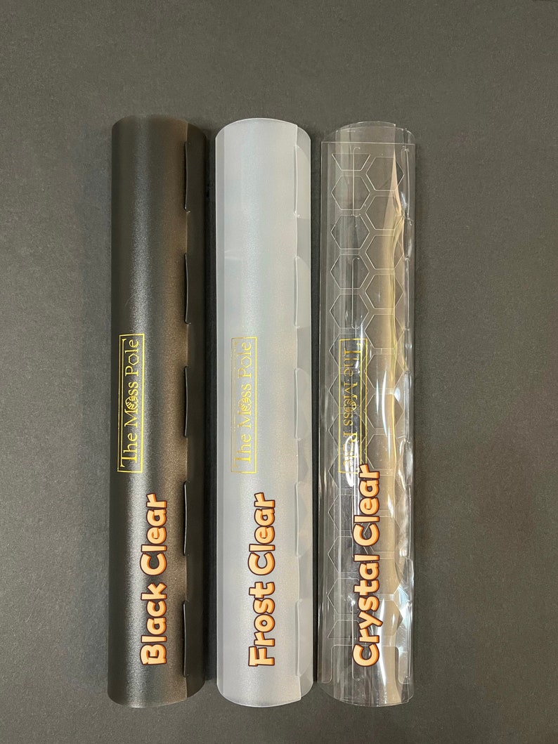 May include: Three clear plastic tubes with different finishes: black, frosted, and crystal clear. Each tube has a gold label with the text "The Mess Pole" and the finish name: "Black Clear", "Frost Clear", and "Crystal Clear".