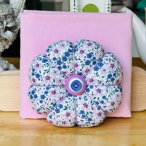 Morning glories and cherry blossoms. Fun spring cushion in pinks and purples. Check out the matching embroidery scissor case with matching scissors in my shop. (Top button on is round on cushion available)