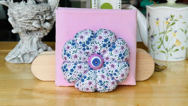 Morning glories and cherry blossoms. Fun spring cushion in pinks and purples. Check out the matching embroidery scissor case with matching scissors in my shop. (Top button on is round on cushion available)