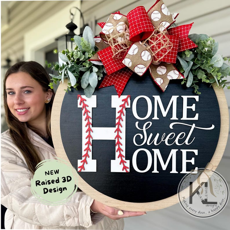 Peut inclure: Une suspension de porte en bois noir et blanc avec le texte "Home Sweet Home" en lettres blanches. Le "H" est d&eacute;cor&eacute; de coutures rouges pour ressembler &agrave; un ballon de baseball. Un n&oelig;ud rouge et blanc sur le th&egrave;me du baseball est attach&eacute; au sommet de la suspension de porte.