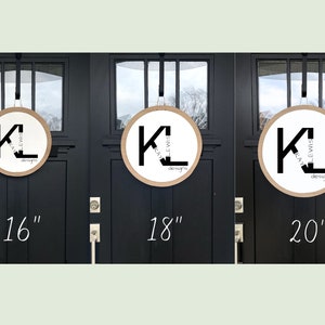 May include: Three round wreaths with a brown wood frame and a white background. The wreaths are decorated with black lettering that reads "K. Lewis Designs" and the letters "K" and "L" are large and stylized. The wreaths are shown hanging on black doors with silver door handles. The wreaths are 16 inches, 18 inches, and 20 inches in diameter.