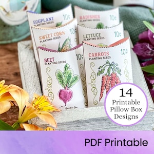 May include: A set of 14 printable pillow box designs featuring various vegetables, including carrots, radishes, lettuce, eggplant, sweet corn, and beets. Each box has a vintage-inspired design with a 10¢ price tag. The boxes are displayed in a wooden crate with flowers.