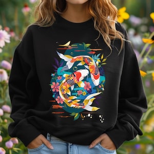 May include: Black sweatshirt with a colorful graphic of two koi fish swimming in a circle surrounded by flowers and leaves.